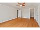 Comfortable bedroom boasts hardwood floors, white trim, and access to additional rooms at 7002 Old Trail Dr, Durham, NC 27712