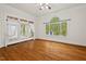 Bedroom featuring hardwood floors, a large window with view of the backyard, and access to the porch at 7002 Old Trail Dr, Durham, NC 27712