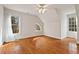 Bedroom featuring hard wood floors, with ample light from the window fixtures at 7002 Old Trail Dr, Durham, NC 27712