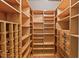 Walk-in closet with custom shelving, drawers, and ample storage space at 7002 Old Trail Dr, Durham, NC 27712