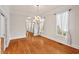 Formal dining room featuring chandelier lighting, hardwood floors and bright windows at 7002 Old Trail Dr, Durham, NC 27712