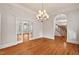 Spacious dining room with hardwood floors, chandelier and entry to the staircase and living room at 7002 Old Trail Dr, Durham, NC 27712
