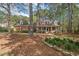 Inviting brick home with a charming front porch and beautiful landscaping at 7002 Old Trail Dr, Durham, NC 27712