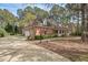 Spacious brick home with a sprawling driveway and mature trees at 7002 Old Trail Dr, Durham, NC 27712
