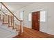 Welcoming foyer with hardwood floors, a staircase, and a front door with sidelights at 7002 Old Trail Dr, Durham, NC 27712