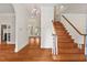 Elegant foyer featuring hardwood floors, a staircase, and chandelier lighting at 7002 Old Trail Dr, Durham, NC 27712