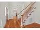 Elegant foyer featuring hardwood floors, a staircase, and a front door with sidelights at 7002 Old Trail Dr, Durham, NC 27712