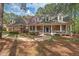 Charming brick home with a welcoming front porch and manicured landscaping at 7002 Old Trail Dr, Durham, NC 27712
