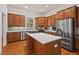 Modern kitchen with stainless steel appliances, a center island, and wood cabinets at 7002 Old Trail Dr, Durham, NC 27712