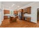 Gourmet kitchen boasts custom cabinets, stainless steel appliances, and center island with breakfast bar at 7002 Old Trail Dr, Durham, NC 27712