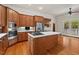Well-equipped kitchen with island, stainless appliances, and bright breakfast area to an outdoor porch at 7002 Old Trail Dr, Durham, NC 27712