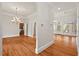 Open-concept living room with hardwood floors, a chandelier, and access to the backyard at 7002 Old Trail Dr, Durham, NC 27712