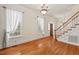 Bright living room with hardwood floors, natural light, and staircase at 7002 Old Trail Dr, Durham, NC 27712