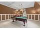 Billiard table underneath pendant lights in a living room with coffered ceilings at 7002 Old Trail Dr, Durham, NC 27712