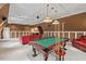 Living room features billiard table, bar area, coffered ceilings, and overhead lighting at 7002 Old Trail Dr, Durham, NC 27712