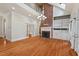 Grand living room with hardwood floors, a fireplace, and built-in shelving at 7002 Old Trail Dr, Durham, NC 27712