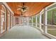 Enclosed sunroom with tile floors, wood ceiling, arched windows and bright natural light at 7002 Old Trail Dr, Durham, NC 27712