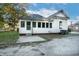 Home exterior shows back door, concrete patio, and vinyl siding under a blue sky at 703 Cokey Rd, Rocky Mount, NC 27801