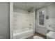 Bathroom featuring a white shower-tub combo, sink, and toilet against a bright window at 703 Cokey Rd, Rocky Mount, NC 27801