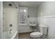 Cozy bathroom with a shower-tub combo, white sink, and toilet with natural light from a window at 703 Cokey Rd, Rocky Mount, NC 27801