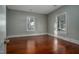 Bedroom featuring hardwood floors, neutral paint, and bright windows offering natural light at 703 Cokey Rd, Rocky Mount, NC 27801
