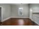 Bedroom with hardwood floors, neutral paint, and a large window providing natural light at 703 Cokey Rd, Rocky Mount, NC 27801