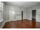 Spacious bedroom with hardwood flooring and neutral paint, featuring a decorative fireplace at 703 Cokey Rd, Rocky Mount, NC 27801