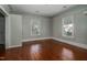 Bedroom featuring hardwood floors, neutral paint, and large windows providing natural light at 703 Cokey Rd, Rocky Mount, NC 27801