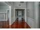 Hallway featuring pristine hardwood floors, neutral paint, and classic trim throughout at 703 Cokey Rd, Rocky Mount, NC 27801