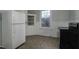 Functional kitchen featuring laminate flooring, white cabinets, and modern appliances at 703 Cokey Rd, Rocky Mount, NC 27801
