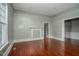 Cozy living room with hardwood floors, white trim, neutral paint, and a decorative fireplace at 703 Cokey Rd, Rocky Mount, NC 27801