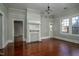 Bright living room with hardwood floors, decorative fireplace, multiple entries, and a neutral color scheme at 703 Cokey Rd, Rocky Mount, NC 27801