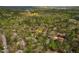 Aerial view showing the property surrounded by trees and with lake in background at 706 Kensington Dr, Chapel Hill, NC 27514