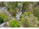 An aerial view of a cozy home nestled among blossoming trees in a lush, green neighborhood at 706 Kensington Dr, Chapel Hill, NC 27514