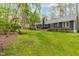 The home features a large backyard with mature trees, a deck, and patio area for entertaining at 706 Kensington Dr, Chapel Hill, NC 27514