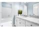 Bright bathroom featuring marble countertops and vanity with white cabinets at 706 Kensington Dr, Chapel Hill, NC 27514