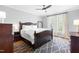 Bedroom with a dark wood bed frame and a patterned rug over hardwood floors at 706 Kensington Dr, Chapel Hill, NC 27514