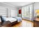 Bedroom with built-in shelving, hardwood floors, and a sunny window at 706 Kensington Dr, Chapel Hill, NC 27514