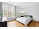Bright bedroom with natural light shining through large windows and hardwood floors at 706 Kensington Dr, Chapel Hill, NC 27514