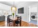 Cozy dining area featuring a wooden table, chandelier, and access to the laundry room at 706 Kensington Dr, Chapel Hill, NC 27514
