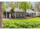 The exterior features a blue color, complemented by lush landscaping, and a well-manicured lawn at 706 Kensington Dr, Chapel Hill, NC 27514