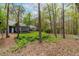 Home exterior featuring mature trees, complemented by lush landscaping, and a well-manicured lawn at 706 Kensington Dr, Chapel Hill, NC 27514