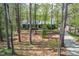 Charming home's exterior showcases a well-maintained yard with mature trees and a paved driveway at 706 Kensington Dr, Chapel Hill, NC 27514
