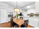 Eat-in kitchen featuring white cabinets, stainless appliances, and hardwood floors at 706 Kensington Dr, Chapel Hill, NC 27514