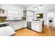 Modern kitchen with bright white cabinets, stainless steel appliances and eat in kitchen area at 706 Kensington Dr, Chapel Hill, NC 27514