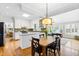 Open concept kitchen featuring white cabinets, stainless steel appliances, and a skylight at 706 Kensington Dr, Chapel Hill, NC 27514