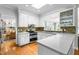Modern kitchen featuring white cabinets, stainless steel appliances, and hardwood floors at 706 Kensington Dr, Chapel Hill, NC 27514