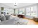 Sun-drenched living room with views of the backyard, featuring hardwood floors and a comfortable couch at 706 Kensington Dr, Chapel Hill, NC 27514