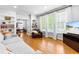 Open living space with hardwood floors, large windows, and comfortable seating area at 706 Kensington Dr, Chapel Hill, NC 27514