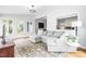 Living room showcasing an open layout with windows, hardwood floors, and comfortable seating at 706 Kensington Dr, Chapel Hill, NC 27514